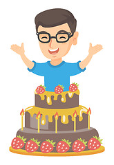 Image showing Little caucasian boy jumping out of a large cake.