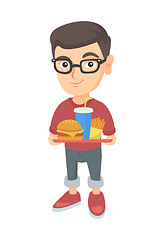 Image showing Little caucasian boy holding tray with fast food.