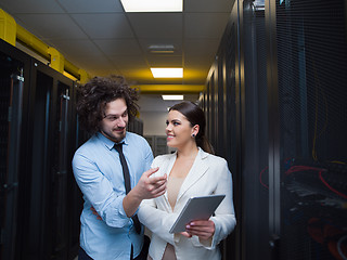 Image showing engineer showing working data center server room to female chief