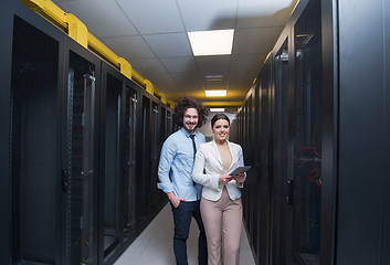 Image showing engineer showing working data center server room to female chief