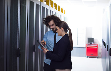 Image showing engineer showing working data center server room to female chief