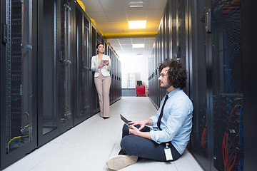 Image showing young technicians working together on servers