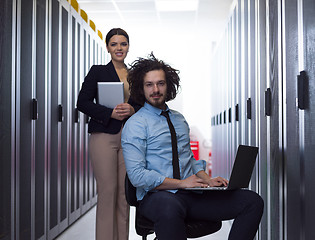 Image showing Team of young technicians working together on servers