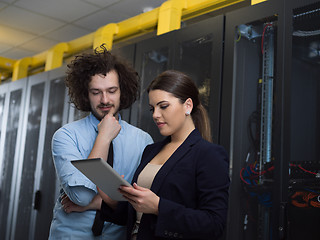 Image showing engineer showing working data center server room to female chief