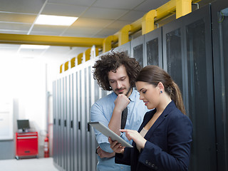 Image showing engineer showing working data center server room to female chief