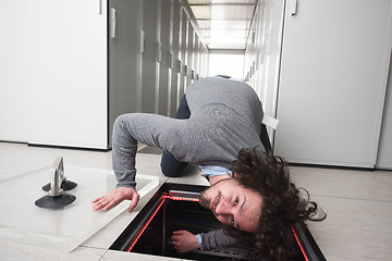 Image showing engineer connecting cables in server room