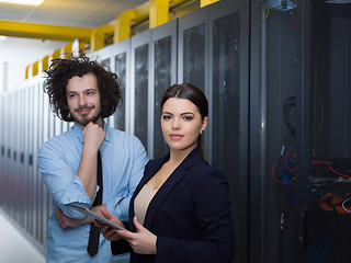 Image showing engineer showing working data center server room to female chief