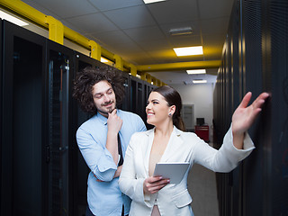 Image showing engineer showing working data center server room to female chief