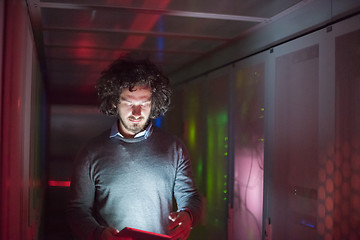 Image showing IT engineer working on a tablet computer in server room