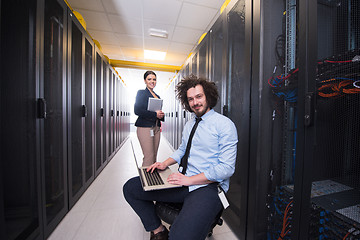 Image showing Team of young technicians working together on servers