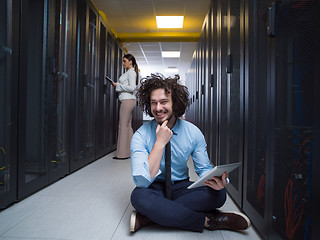 Image showing young technicians working together on servers