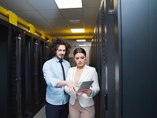 Image showing engineer showing working data center server room to female chief