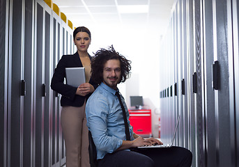 Image showing Team of young technicians working together on servers