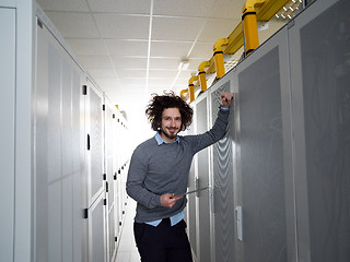 Image showing IT engineer working on a tablet computer in server room