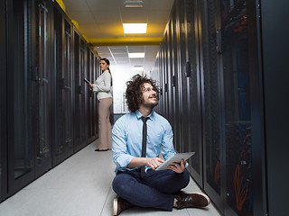 Image showing young technicians working together on servers