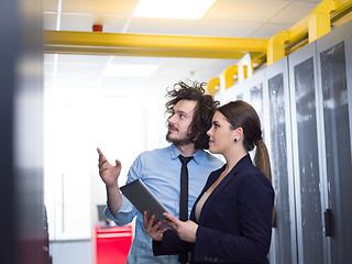 Image showing engineer showing working data center server room to female chief