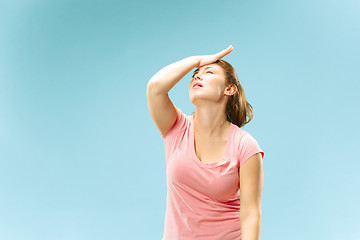 Image showing Woman having headache. Isolated over pastel background.