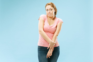 Image showing Beautiful woman looking suprised and bewildered isolated on blue