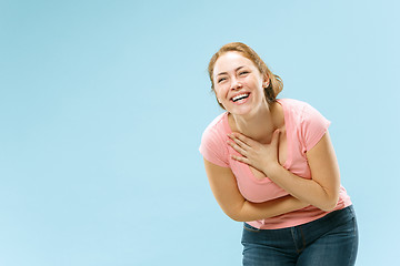 Image showing The happy business woman standing and smiling against pastel background.