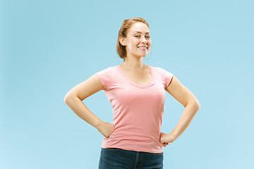 Image showing The happy business woman standing and smiling against pastel background.