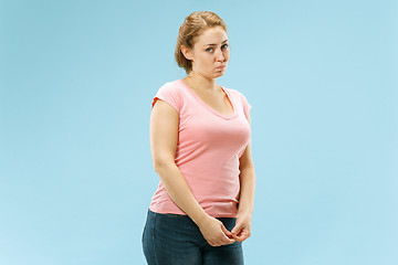 Image showing Beautiful woman looking suprised and bewildered isolated on blue