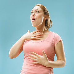 Image showing Beautiful woman looking suprised isolated on blue