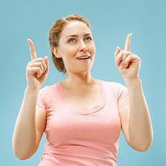 Image showing Beautiful woman looking suprised isolated on blue