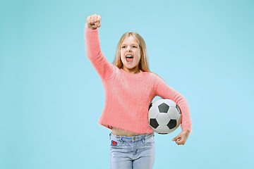 Image showing Fan sport teen player holding soccer ball isolated on blue background