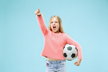 Image showing Fan sport teen player holding soccer ball isolated on blue background