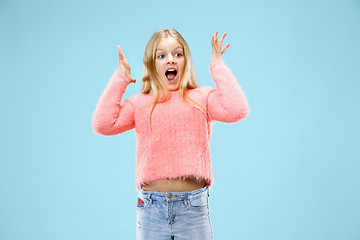 Image showing Beautiful teen girl looking suprised isolated on blue