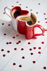 Image showing Two heart shaped coffee cups conected with each other.