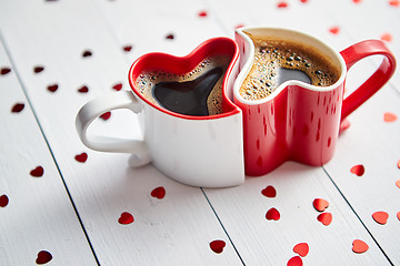 Image showing Two heart shaped coffee cups conected with each other.