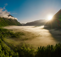 Image showing Morning mist over the valley among the mountains in the sunlight