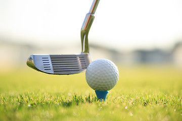 Image showing Golf ball on tee in front of driver