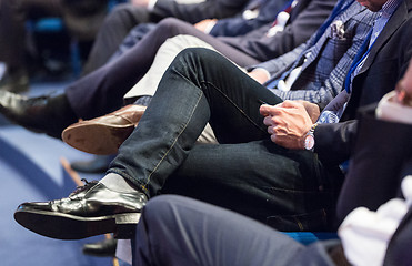 Image showing Row of business people sitting at seminar.