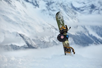 Image showing Snowboard on a mountain top