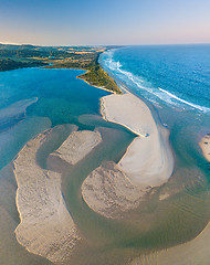 Image showing Aerial view of sand patterns in the shallow waters of the ocean 