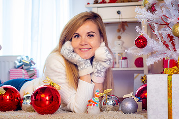 Image showing Portrait of a young girl lying at a Christmas tree