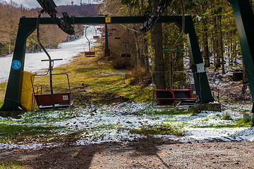 Image showing Empty ski lift chairs sitting idle during the off season