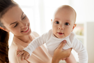 Image showing happy mother playing with little baby boy at home