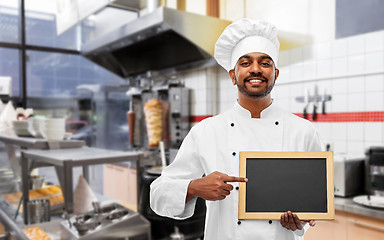 Image showing happy indian chef with chalkboard at kebab shop