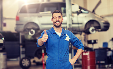 Image showing happy auto mechanic man or smith at car workshop