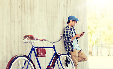 Image showing man with smartphone, earphones and bicycle