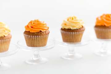 Image showing cupcakes with frosting on confectionery stands