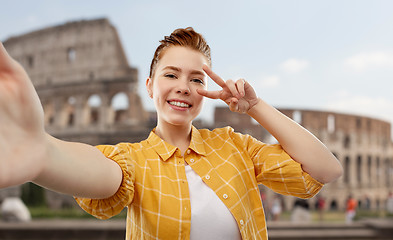 Image showing redhead teenage girl taking selfie over coliseum