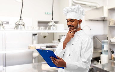 Image showing indian chef with clipboard at restaurant kitchen