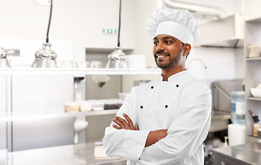 Image showing smiling indian chef at restaurant kitchen