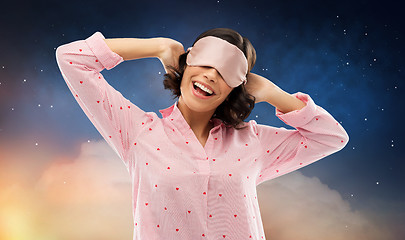 Image showing happy young woman in pajama and eye sleeping mask