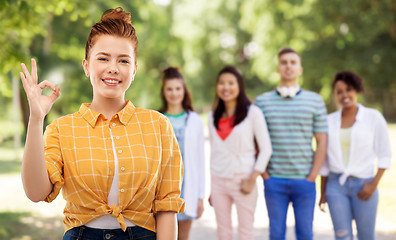 Image showing happy red haired teenage girl showing ok hand sign