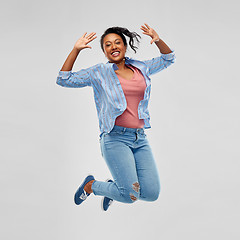 Image showing happy african american woman jumping high